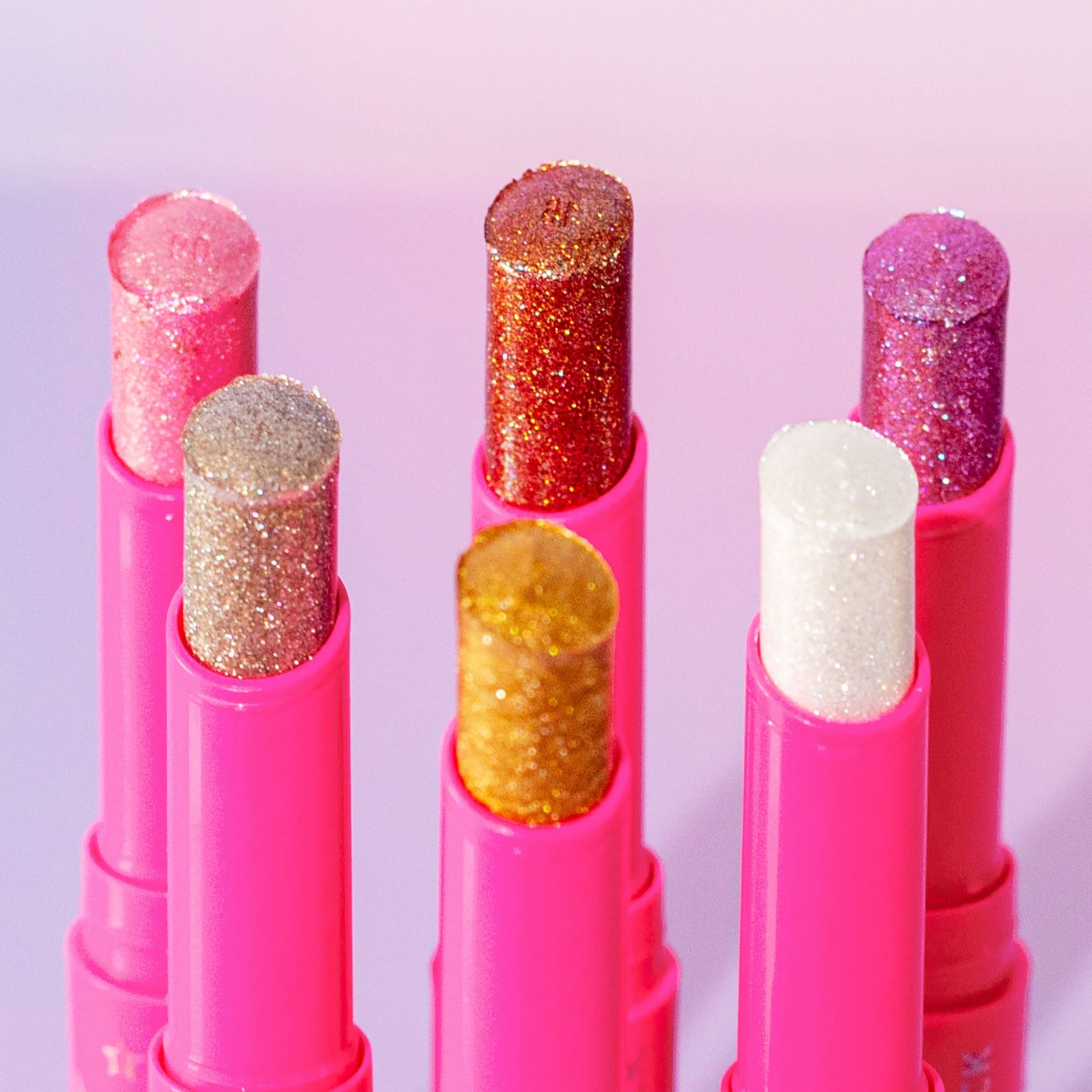 6 jelly multi use jelly sticks with glittery texture on a light purple background