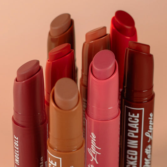 Collection of Matte Lippie lipsticks in various shades on a beige background