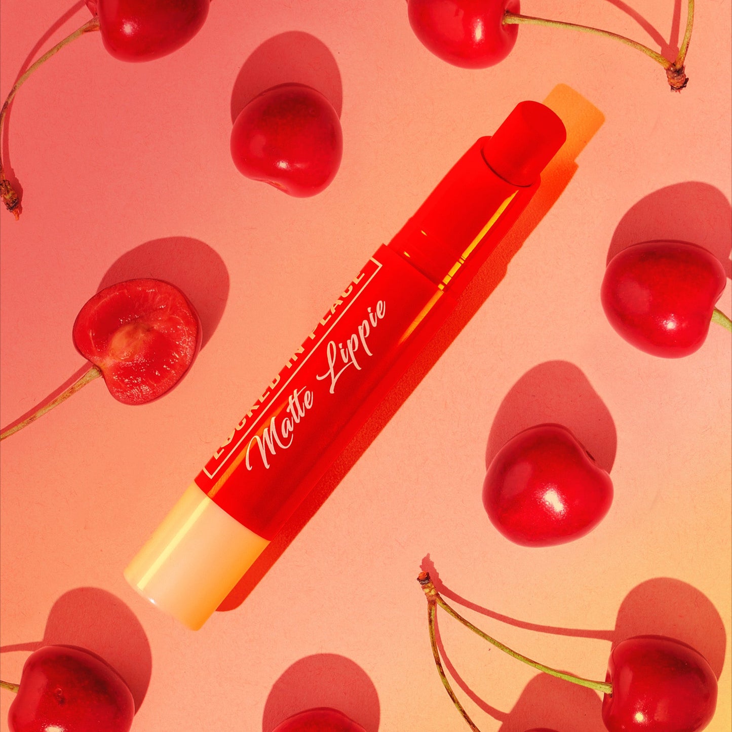 italia deluxe nonstransfer, colorstay, matte lippies on a yellow, red, pink accents background with cherries, it is cherry flavored, cherry scent. 