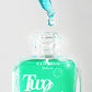 Turquoise face serum bottle with dropper labeled 'Italia Deluxe Two Phase' on a light gray background