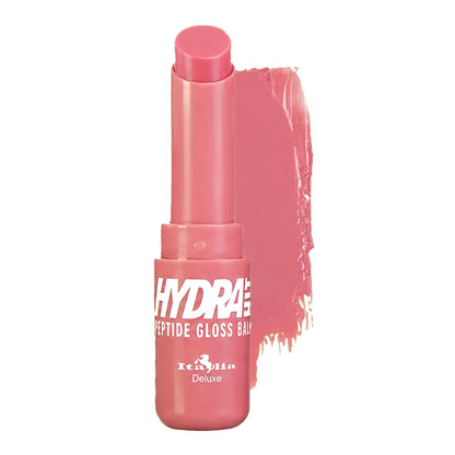 A tube of Italia Deluxe Hydrahit Peptide Gloss Balm in a pink shade,  shown with a glossy smear of the product behind it on a white background.