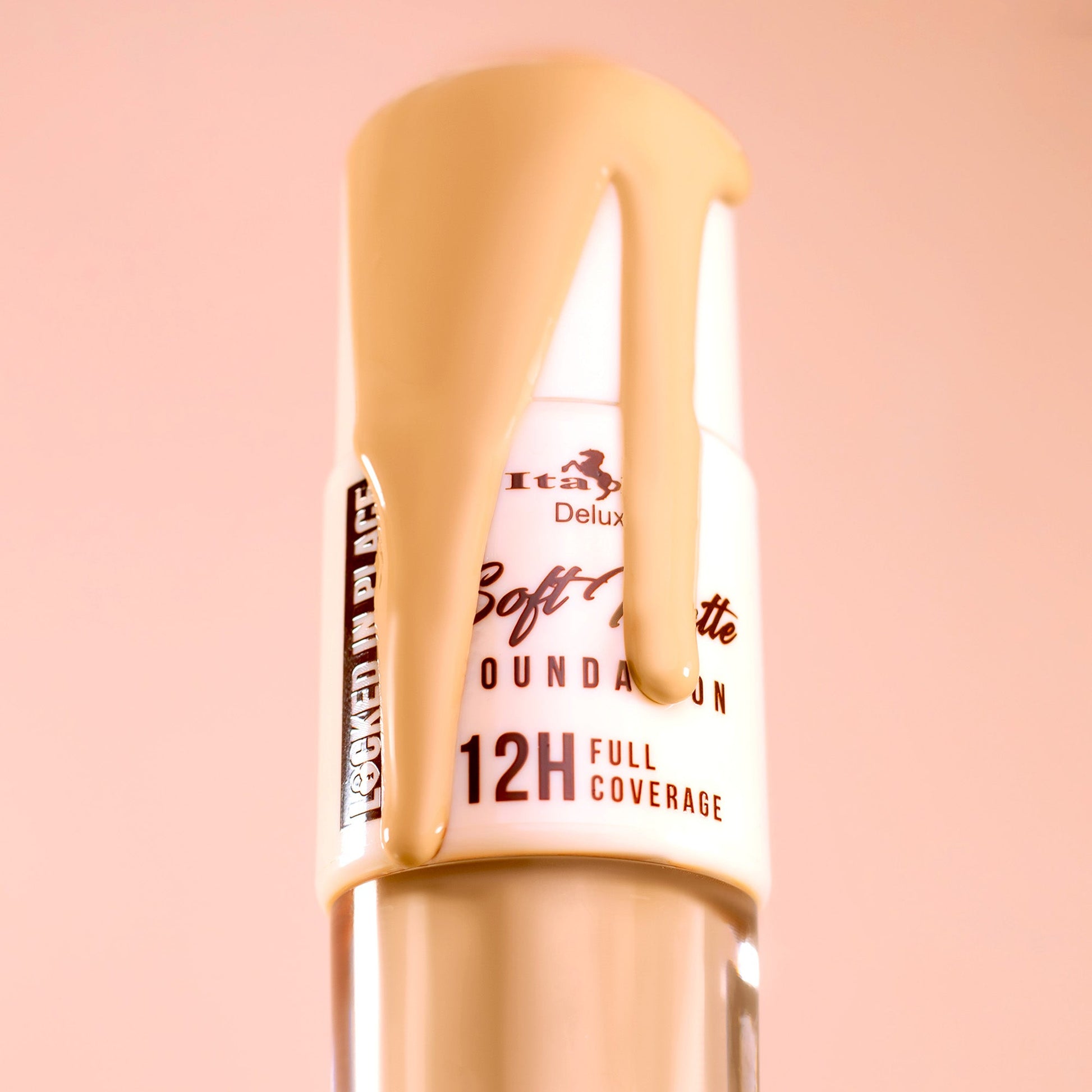 Italia Deluxe Soft Matte Foundation bottle with foundation dripping over the top, showcasing full coverage, blurred skin finish, and long-wear formula.