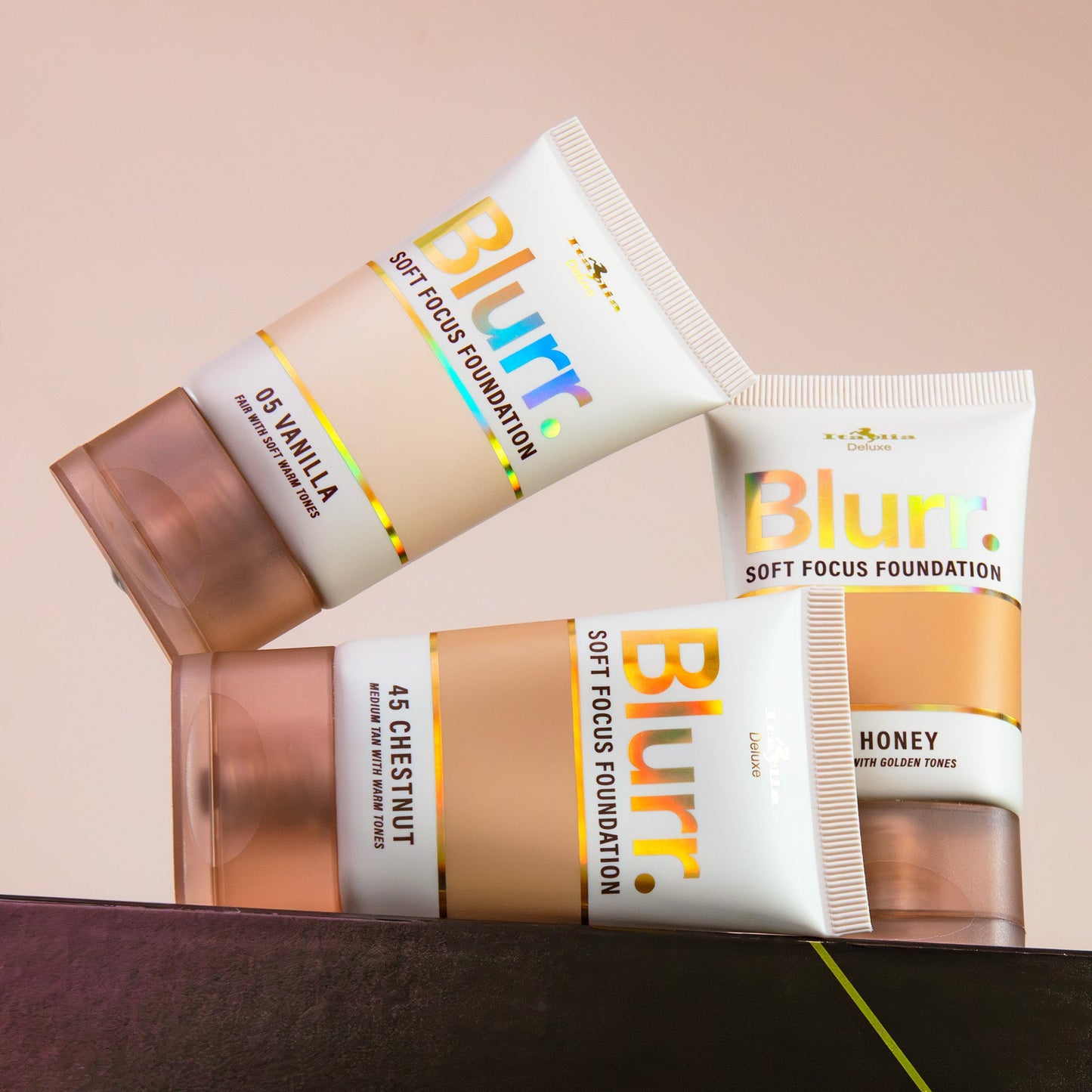 Two tubes of Blurr soft focus foundation on a beige background