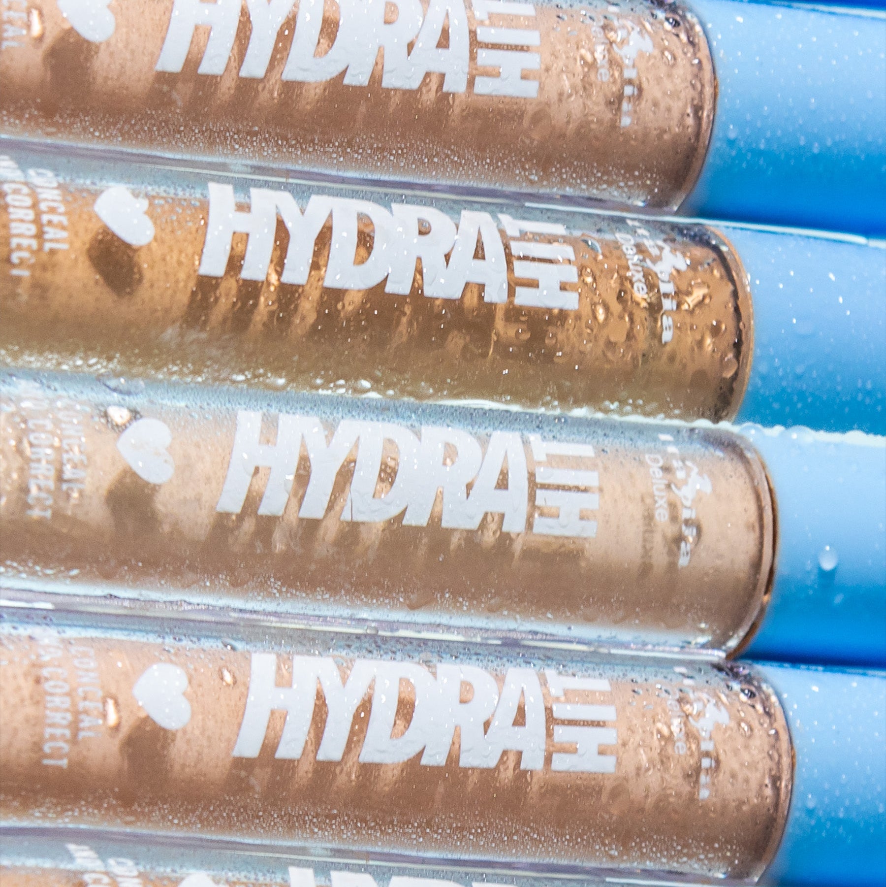 Close-up of HydraHit, hydrating creamy concealer tubes. 