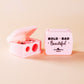 Pink COSMETIC SHARPENER with 'Bold Bad Beautiful' text on a beige background