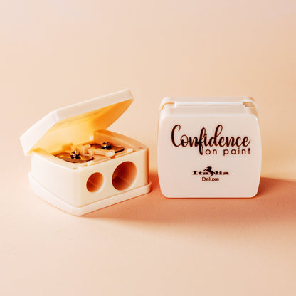 BEIGE COSMETIC SHARPENER WITH 'Confidence on Point' text on a beige background